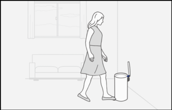 Woman is opening the trash can lid